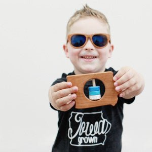 boy holding Iowa State Wooden Baby Rattle™ - Bannor-toys